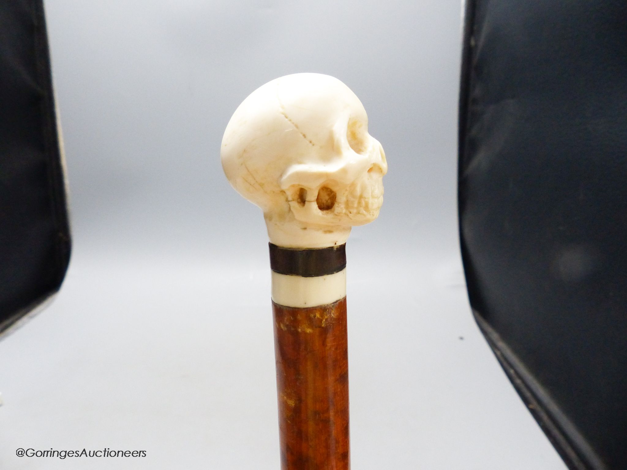 A malacca and ivory skull handled walking stick
